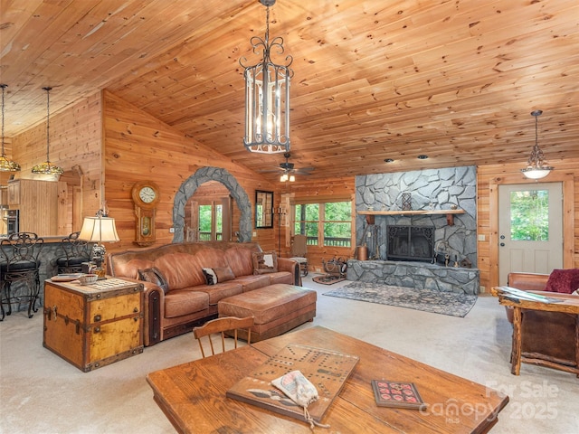 47 Tammy Dr, Maggie Valley, NC 28751 - carpeted living area with plenty of natural light, wood ceiling, wood walls, a chandelier, and a fireplace