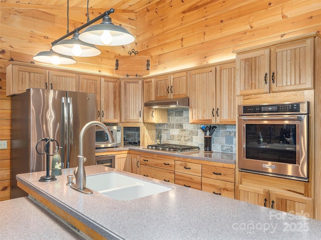 47 Tammy Dr, Maggie Valley, NC 28751 - kitchen featuring appliances with stainless steel finishes, under cabinet range hood, wooden walls, backsplash, and pendant lighting