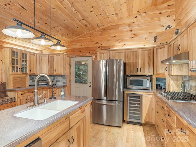 47 Tammy Dr, Maggie Valley, NC 28751 - kitchen with stainless steel appliances, a sink, beverage cooler, vaulted ceiling, and range hood