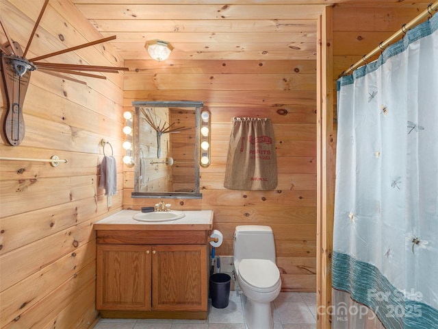 47 Tammy Dr, Maggie Valley, NC 28751 - bathroom featuring wood walls, vanity, toilet, tile patterned flooring, and curtained shower