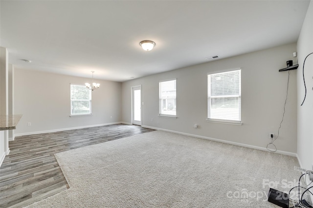 463 W Barr St, Lancaster, SC 29720 - unfurnished living room with a chandelier, baseboards, and wood finished floors