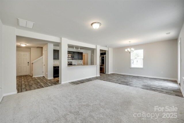463 W Barr St, Lancaster, SC 29720 - unfurnished living room featuring a sink, a chandelier, baseboards, and carpet flooring