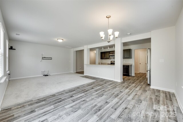 463 W Barr St, Lancaster, SC 29720 - unfurnished living room featuring a chandelier, light wood finished floors, and baseboards