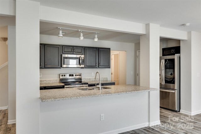 463 W Barr St, Lancaster, SC 29720 - kitchen with appliances with stainless steel finishes, a sink, light wood-style flooring, baseboards, and light stone counters