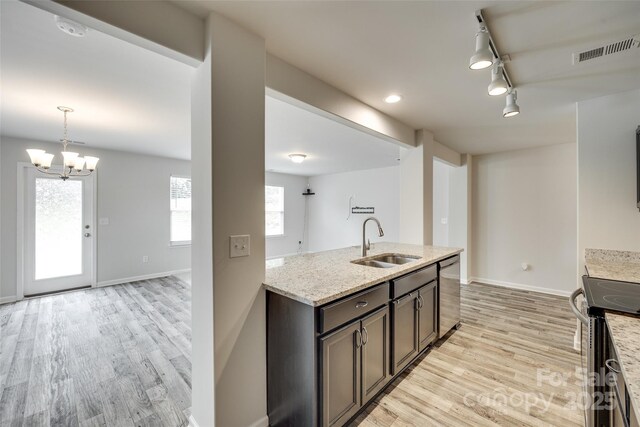 463 W Barr St, Lancaster, SC 29720 - kitchen featuring a sink, stainless steel appliances, rail lighting, light stone countertops, and a chandelier