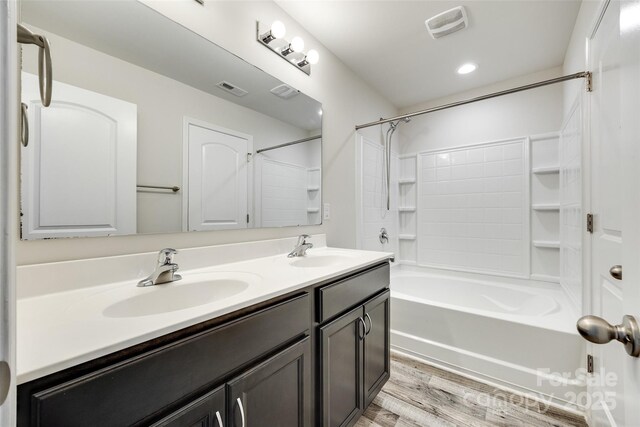 463 W Barr St, Lancaster, SC 29720 - full bathroom with double vanity, bathtub / shower combination, wood finished floors, and recessed lighting