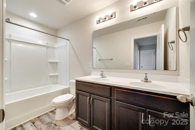 463 W Barr St, Lancaster, SC 29720 - bathroom with double vanity, toilet, wood finished floors, and washtub / shower combination