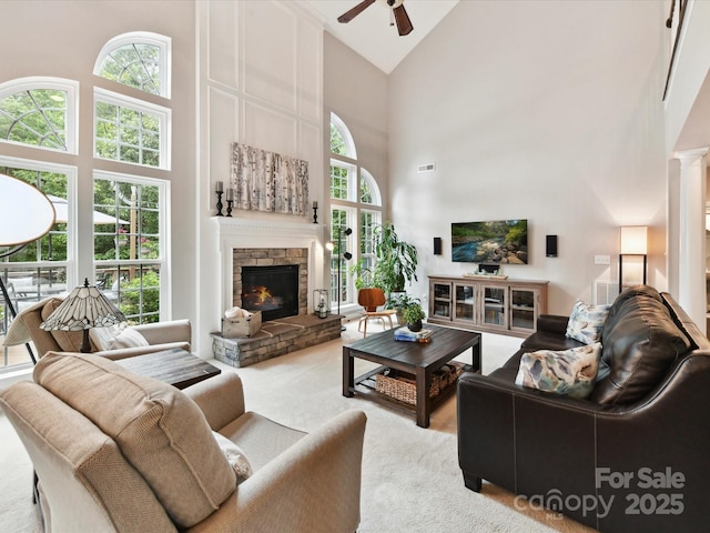 105 Beech Bluff Dr, Mount Holly, NC 28120 - living area featuring high vaulted ceiling, a ceiling fan, carpet flooring, and a stone fireplace