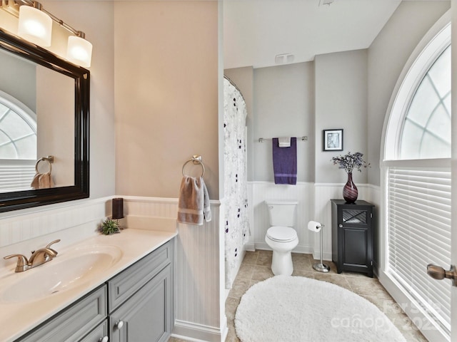 105 Beech Bluff Dr, Mount Holly, NC 28120 - bathroom with wainscoting, vanity, curtained shower, and tile patterned flooring
