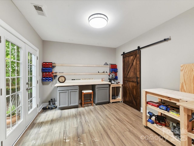 105 Beech Bluff Dr, Mount Holly, NC 28120 - interior space with a barn door, light wood finished floors, and french doors