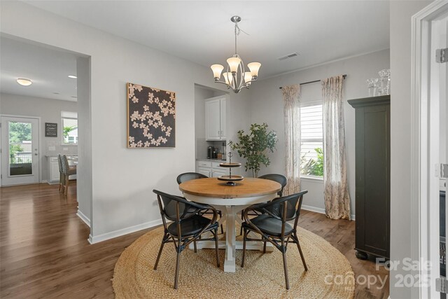 1826 Goodheart Ln, York, SC 29745 - dining area with wood finished floors, a chandelier, healthy amount of natural light, and baseboards