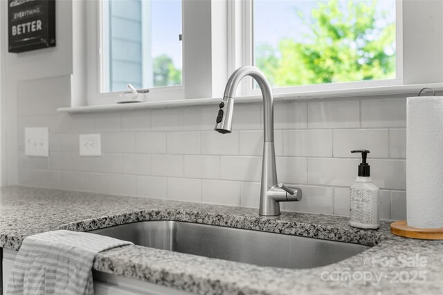 1826 Goodheart Ln, York, SC 29745 - kitchen view of tasteful backsplash, a sink, and light stone counters