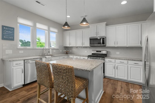 1826 Goodheart Ln, York, SC 29745 - kitchen featuring appliances with stainless steel finishes, a sink, white cabinetry, and recessed lighting