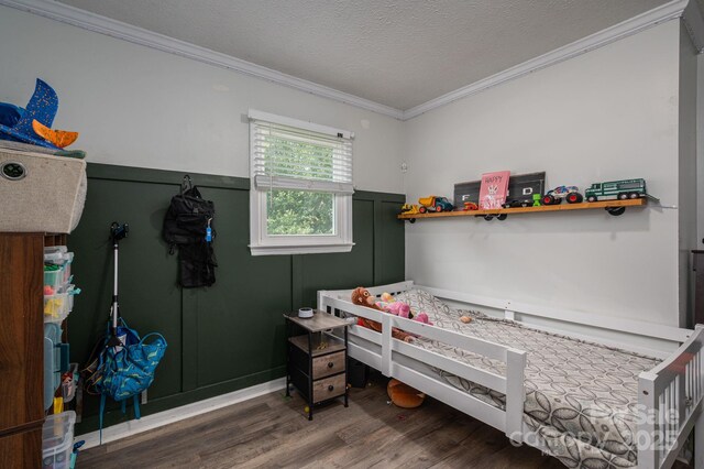2206 Whitworth Rd, Cherryville, NC 28021 - bedroom with wood finished floors, ornamental molding, a textured ceiling, and a wainscoted wall