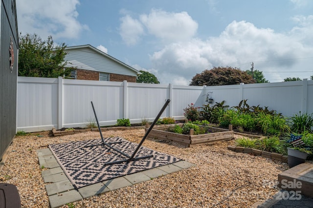 2206 Whitworth Rd, Cherryville, NC 28021 - fenced backyard with a vegetable garden and a patio