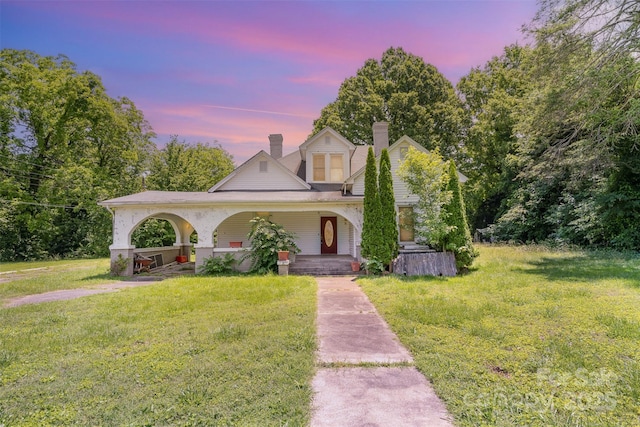 1637 N College Ave, Newton, NC 28658 - view of front of property with a porch, a chimney, and a lawn