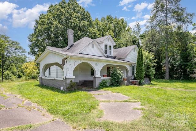 1637 N College Ave, Newton, NC 28658 - view of front of home featuring covered porch, a chimney, and a front lawn
