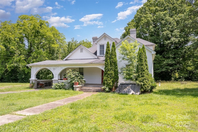 1637 N College Ave, Newton, NC 28658 - view of front of house with covered porch, a front yard, and a chimney