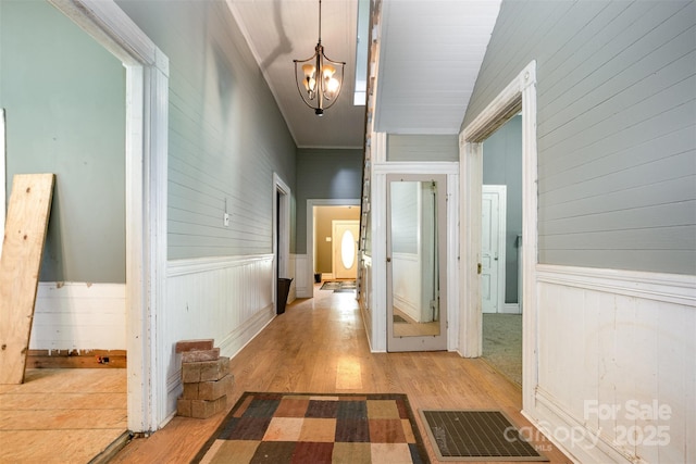 1637 N College Ave, Newton, NC 28658 - hall with a chandelier, wood finished floors, a wainscoted wall, and wood walls