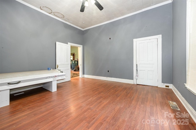 1637 N College Ave, Newton, NC 28658 - unfurnished bedroom with ornamental molding, wood finished floors, baseboards, and ceiling fan