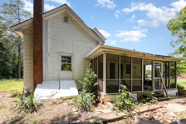 1637 N College Ave, Newton, NC 28658 - rear view of house with a sunroom and a chimney