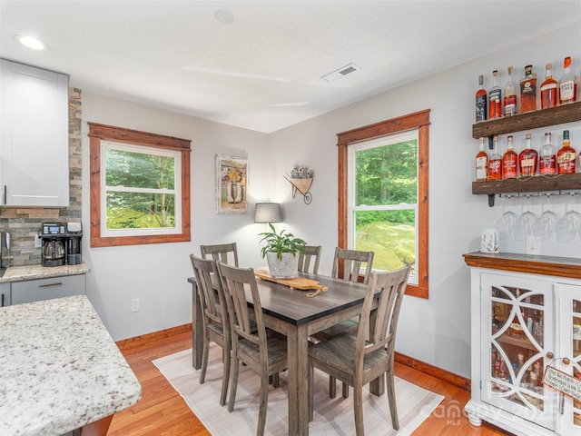 1903 Mauney Cove Rd, Waynesville, NC 28786 - dining space with a bar, plenty of natural light, light wood-type flooring, and recessed lighting