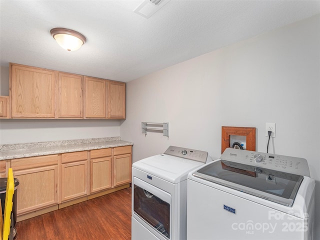 1903 Mauney Cove Rd, Waynesville, NC 28786 - laundry room with washing machine and clothes dryer, dark wood-type flooring, and cabinet space