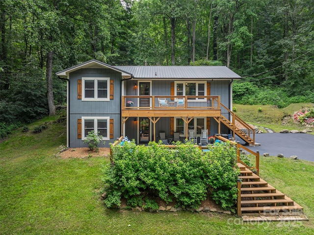 1903 Mauney Cove Rd, Waynesville, NC 28786 - rear view of house with stairway, a lawn, a metal roof, a deck, and a forest view