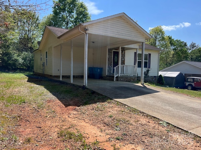 22 Congress St, Granite Falls, NC 28630 - view of front of property featuring driveway, an attached carport, crawl space, and covered porch