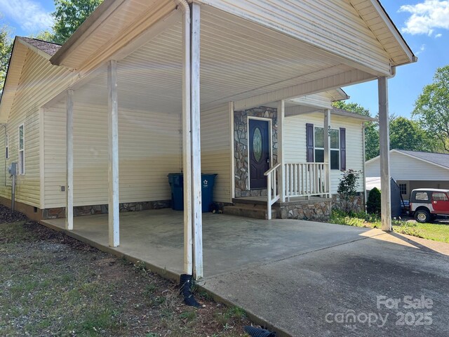 22 Congress St, Granite Falls, NC 28630 - view of home's exterior with an attached carport, concrete driveway, covered porch, and crawl space