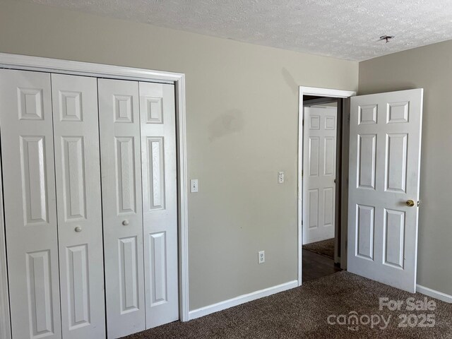 22 Congress St, Granite Falls, NC 28630 - unfurnished bedroom with dark colored carpet, a textured ceiling, and a closet