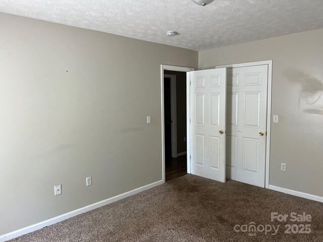 22 Congress St, Granite Falls, NC 28630 - unfurnished bedroom featuring dark carpet and a textured ceiling