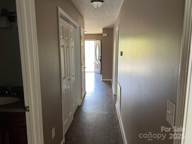 22 Congress St, Granite Falls, NC 28630 - corridor with a textured ceiling and dark wood-type flooring