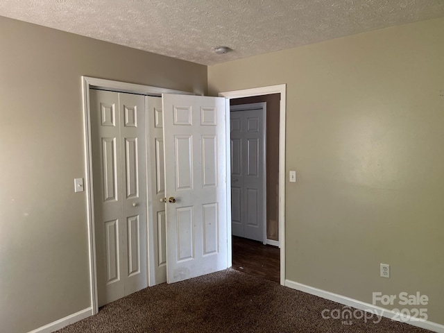 22 Congress St, Granite Falls, NC 28630 - unfurnished bedroom featuring carpet floors, a textured ceiling, and a closet