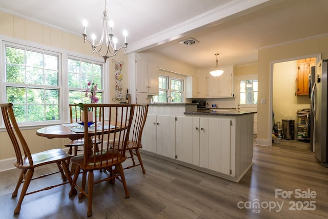 613 E Ridge St, Kings Mountain, NC 28086 - dining room featuring crown molding, wood finished floors, and a chandelier