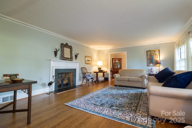 613 E Ridge St, Kings Mountain, NC 28086 - living area with crown molding, wood finished floors, and a fireplace with raised hearth