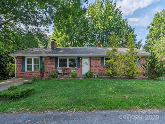 151 Ingram Loop, Clyde, NC 28721 - ranch-style home with a chimney, brick siding, a front lawn, and a porch