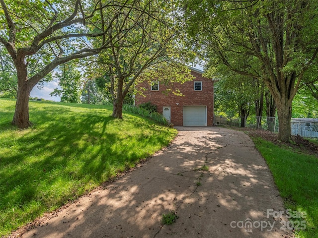 151 Ingram Loop, Clyde, NC 28721 - view of front of property with brick siding, driveway, and a garage