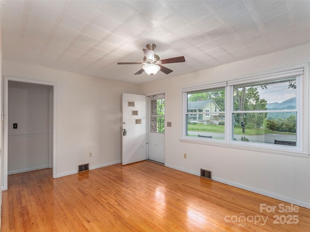 151 Ingram Loop, Clyde, NC 28721 - unfurnished room featuring a ceiling fan, baseboards, and light wood-style flooring