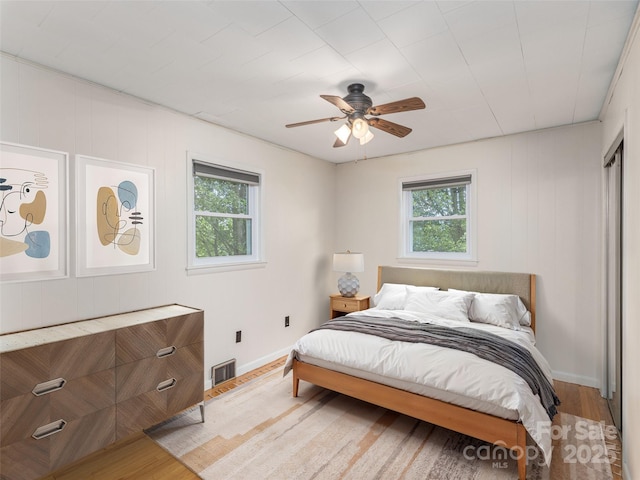151 Ingram Loop, Clyde, NC 28721 - bedroom with multiple windows, light wood finished floors, baseboards, and a ceiling fan