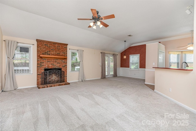 137 Citation Dr, Mooresville, NC 28117 - unfurnished living room with a ceiling fan, vaulted ceiling, a brick fireplace, and carpet flooring