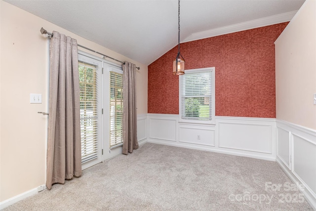 137 Citation Dr, Mooresville, NC 28117 - unfurnished dining area with vaulted ceiling, healthy amount of natural light, a wainscoted wall, carpet, and crown molding