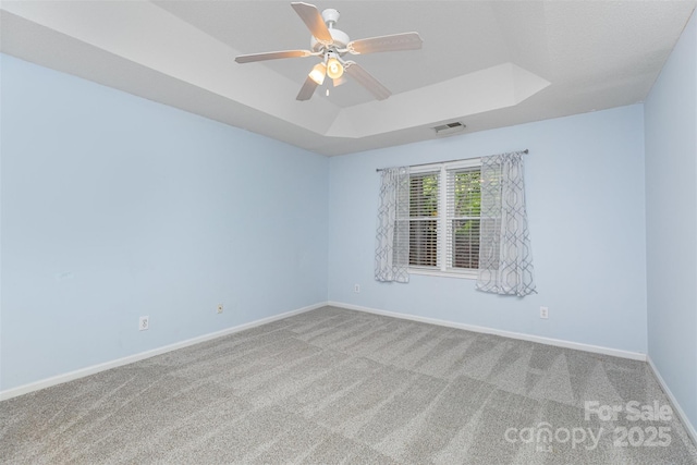 137 Citation Dr, Mooresville, NC 28117 - empty room featuring a raised ceiling, carpet floors, and ceiling fan