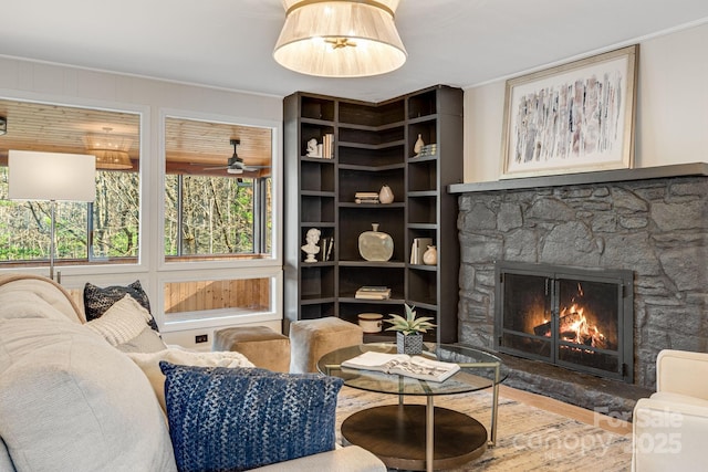 471 Highlands View Rd, Highlands, NC 28741 - living room featuring a stone fireplace, crown molding, a ceiling fan, and wood finished floors