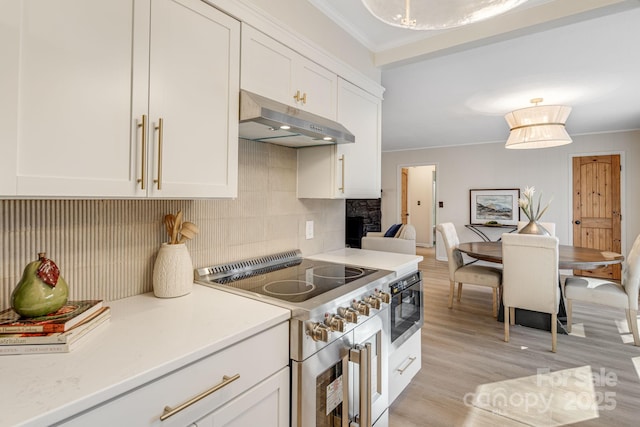 471 Highlands View Rd, Highlands, NC 28741 - kitchen with under cabinet range hood, stainless steel appliances, crown molding, white cabinets, and backsplash