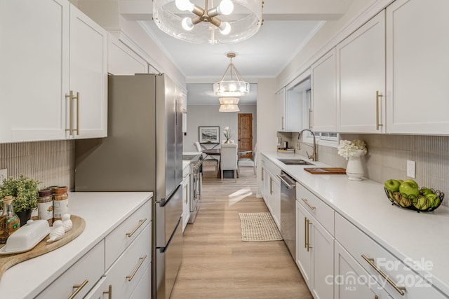 471 Highlands View Rd, Highlands, NC 28741 - kitchen featuring a sink, a chandelier, stainless steel appliances, white cabinets, and ornamental molding