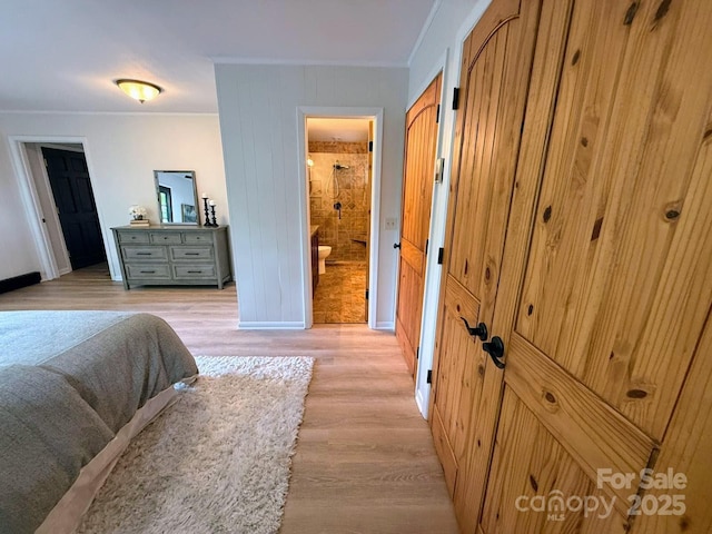 471 Highlands View Rd, Highlands, NC 28741 - bedroom featuring crown molding, light wood-style floors, baseboards, connected bathroom, and wood walls