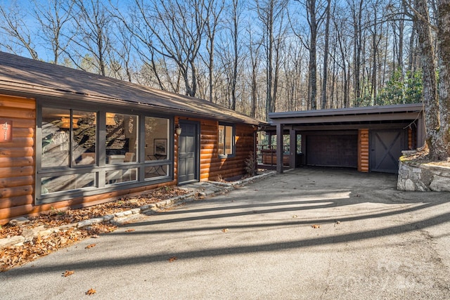 471 Highlands View Rd, Highlands, NC 28741 - view of front of house with an outdoor structure, log veneer siding, and driveway