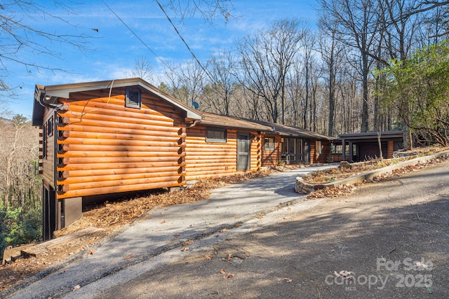 471 Highlands View Rd, Highlands, NC 28741 - log-style house featuring asphalt driveway and log exterior