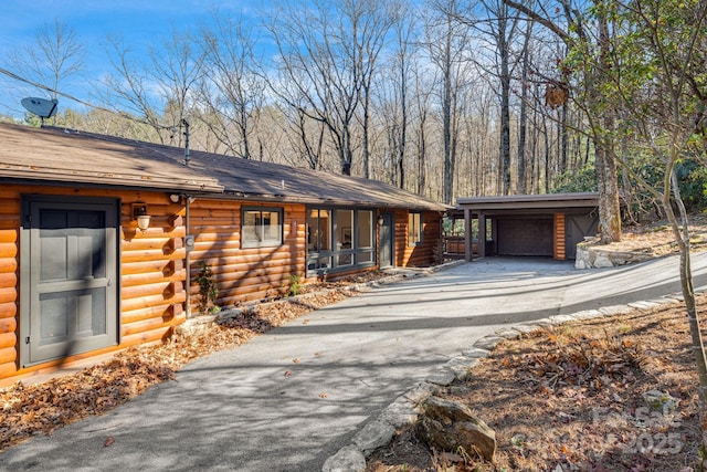 471 Highlands View Rd, Highlands, NC 28741 - view of home's exterior with log exterior, an outbuilding, a garage, and a porch